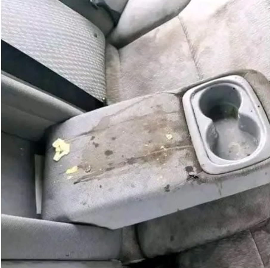 Stained rear-seat armrest before interior detailing